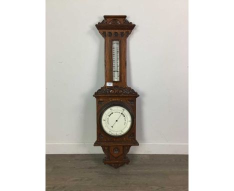LATE VICTORIAN OAK CASED ANEROID BAROMETER AND THERMOMETER,with circular dial, carved and moulded detail, 97cm long
