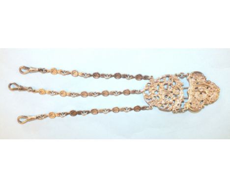 An Edwardian silver chatelaine, with two linked plates, pierced and moulded with figures amidst scroll work, with three chain