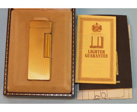 A Dunhill gold-plated lighter in original fitted box with paperwork, dated 1983.