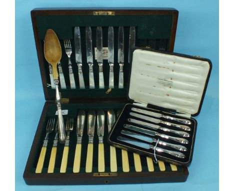 A set of six each mother-of-pearl-handled dessert knives and forks, a set of fish eaters in case, a set of six tea knives and