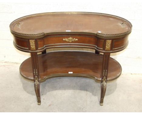 A 19th century French two-tier gallery top mahogany butler's table, the kidney-shaped top with removable tray, on shaped legs