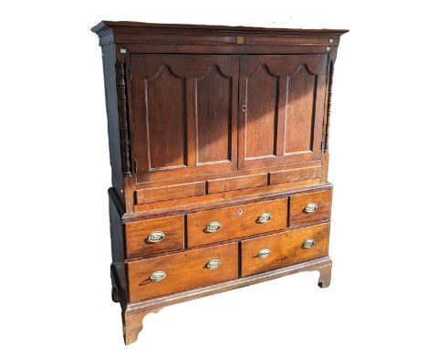 A Georgian oak Linen Press,&nbsp;with moulded cornice over two panelled doors, above base with drawers on shaped bracket feet