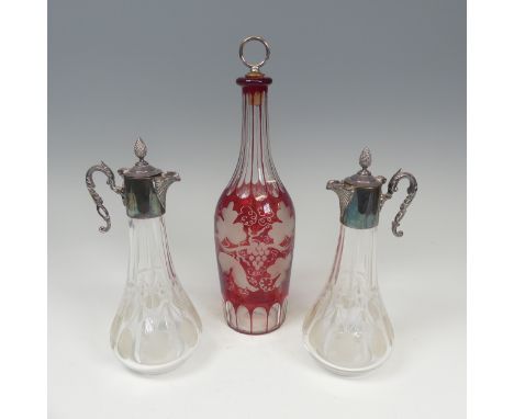 A good cut and etched Ruby Flash glass Decanter,&nbsp;H 30 cm, together with two other etched glass and metal topped Decanter