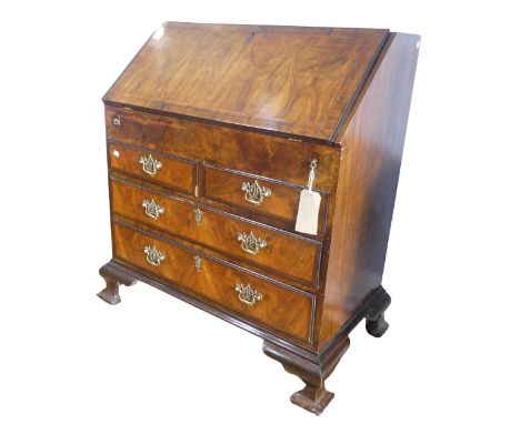 A small Georgian mahogany Bureau, sloped fall front concealing fitted interior with ; pigeon holes, drawers and hidden compar