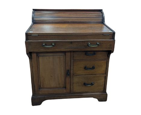 A mahogany 'Bradford Desk' by Christopher Pratt &amp; Sons,&nbsp;the frieze drawer operating a tambour top section enclosing 