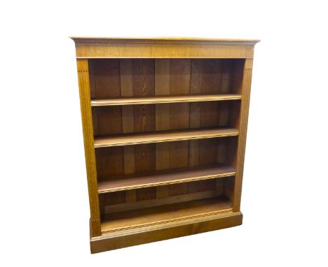 An Edwardian light oak open Bookcase, with four adjustable shelves flanked by pilasters on plinth base, W 112 cm x H 134 cm x