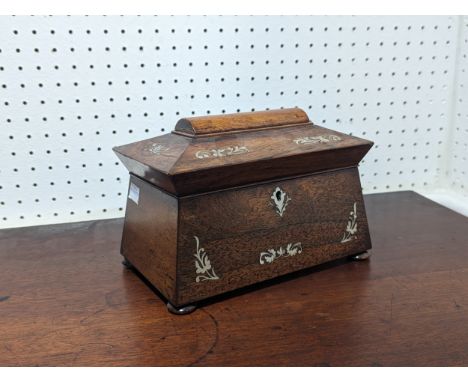 An antique Regency style rosewood and mother of pearl sarcophagus tea Caddy, fitted interior and raised on flat bun feet, W 2