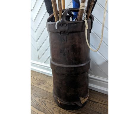 A 19th century leather artillery Cordite (shell carrier),&nbsp;cylindrical body with a raised band and twinned leather carry 
