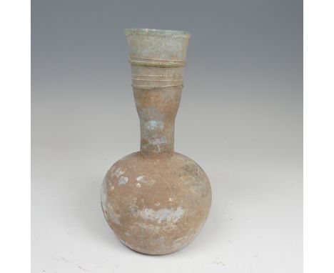 A Roman iridescent glass Flask, c. 2-3 century AD, of bulbous body with tapering ribbon trailed neck, H 20.5cm. 