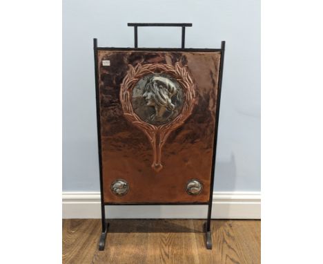 A rare Arts and Crafts copper and pewter Fire Screen, wrought iron surround enclosing embossed copper panel with a central pe