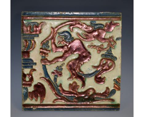 A Hispano-Moresque lustre tile, decorated with a stylised figure amongst scrolling branches, terminating in a bird, 18cm wide