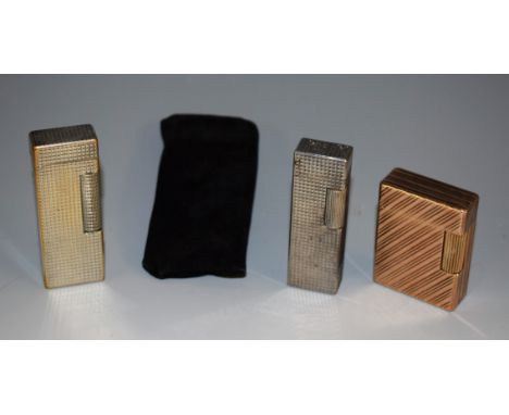 A Dupont gilt metal cigarette lighter, no.BY6914, 4.5cm high; others (3)