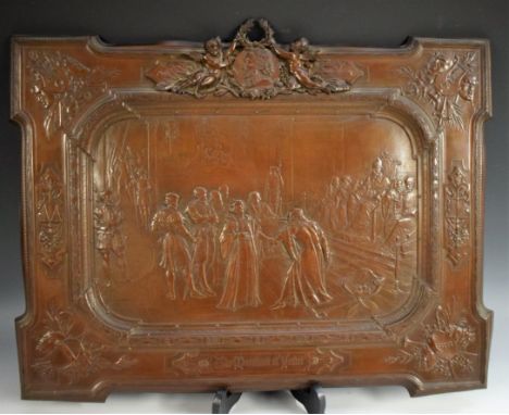 A Victorian copper panel, embossed with a titled scene from the Merchant of Venice, the border crested by a portrait roundel 