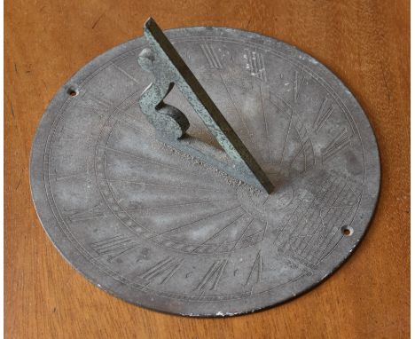 A verdigris patinated circular sundial, shaped and pierced gnomon, 15.5cm diam