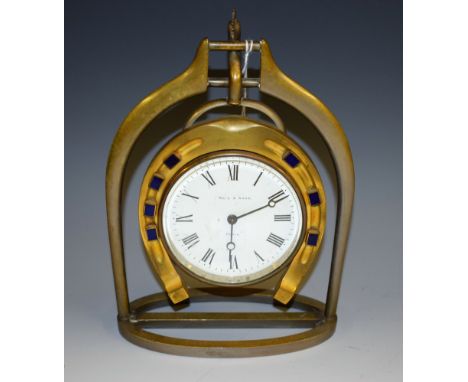 Equestrian - an early 20th century novelty desk timepiece, a s a horseshoe suspended within a stirrup, 8.5cm circular enamel 