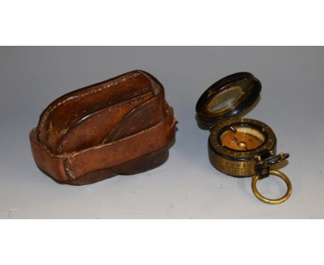 A Negretti & Zambra military compass, inscribed J F Brady RFA, 7.5cm over loop, brown leather case