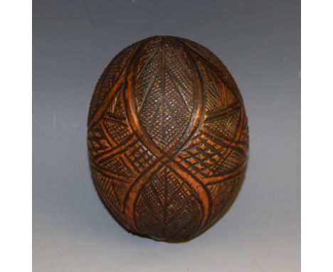 A 19th century carved coconut 'bug bear' flask, 13cm long