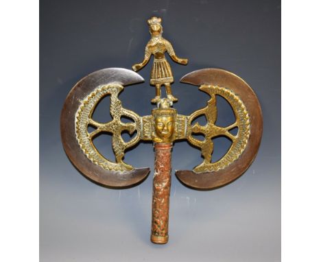 An Indian copper and brass double-sided axe head, 13cm steel  crescent shaped blades engraved with pricked scrolls, figural f