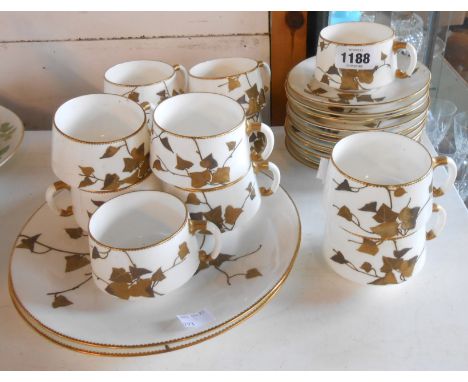 A 19th Century bone china part tea set with gilt ivy leaf decoration comprising twelve cups and saucers and two bread and but