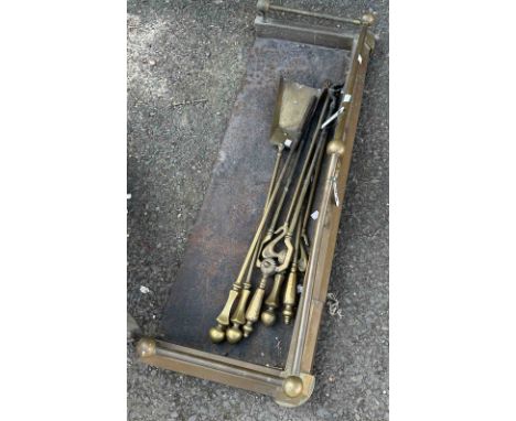A brass fire fender - sold with a quantity of fire tools