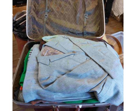 A vintage suitcase containing a large quantity of assorted vintage fashion items and textiles