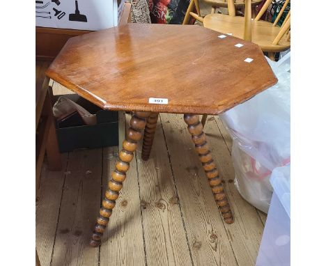 A 59cm early 20th Century oak octagonal topped cricket table, set on bobbin turned legs