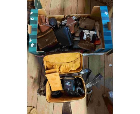 A box containing a collection of assorted cameras including Kodak examples