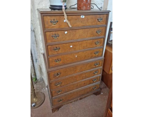 A 77cm reproduction walnut chest on chest with flight of eight long drawers, set on bracket feet
