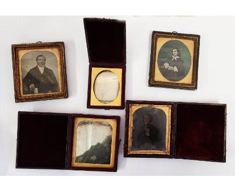 A bag containing two leather folding cased daguerreotypes, a similarly cased ambrotype and two further framed ambrotypes (one