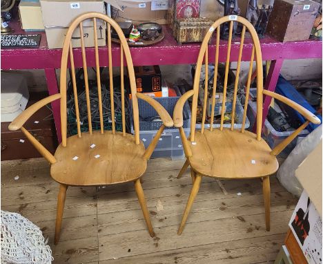 A pair of vintage Ercol light elm hoop stick back carver chairs, set on turned supports - one with silver label
