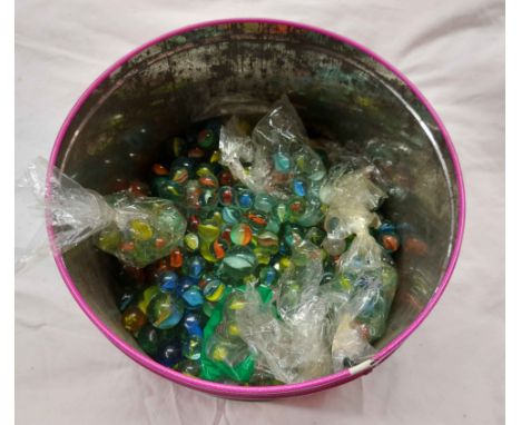 A tin containing a quantity of glass marbles