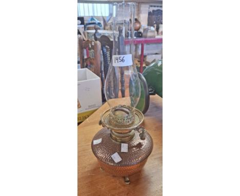 A Victorian Benham &amp; Froud beaten copper oil lamp with Hink's Duplex burner and Messenger's Patent cigar lighter, set on 