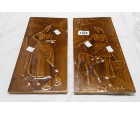A pair of late 19th Century Craven Dunnill &amp; Co ceramic tiles with relief moulded decoration, depicting a young farm girl