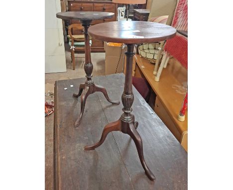 A pair of stained wood wine tables, both set on turned pillar and tripod base