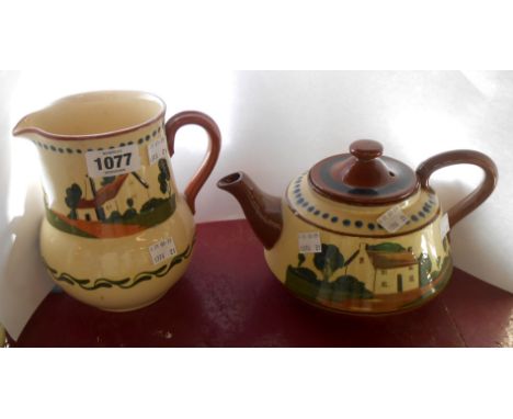 A large Watcombe Torquay pottery teapot with cottage and motto decoration - sold with a similar jug