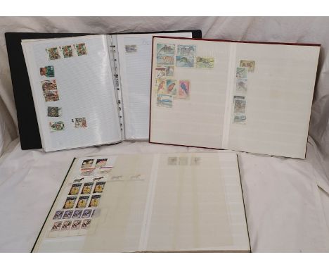 Two stock albums with part contents of 20th Century world commemorative stamps - sold with a black ring bound album containin