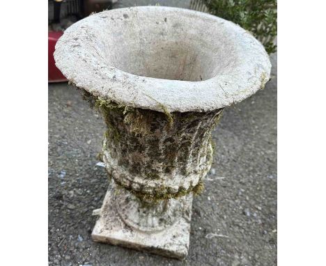 A stone garden urn of typical style