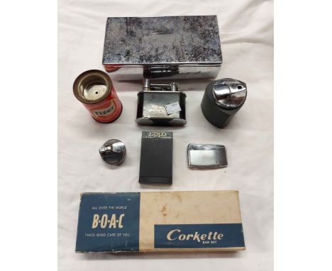 A box containing a quantity of assorted of lighters including cased Zippo with engraved German Shepherd design, Tizer example