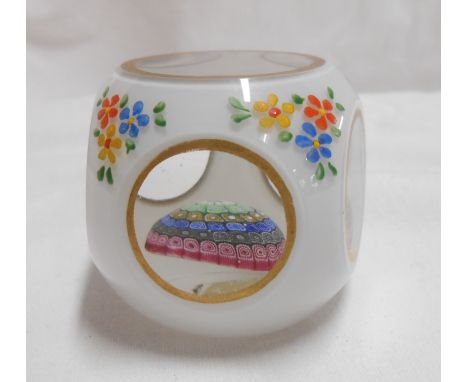A vintage Murano glass paperweight with central internal millefiori ground with a white opaque glass cased window cut body wi