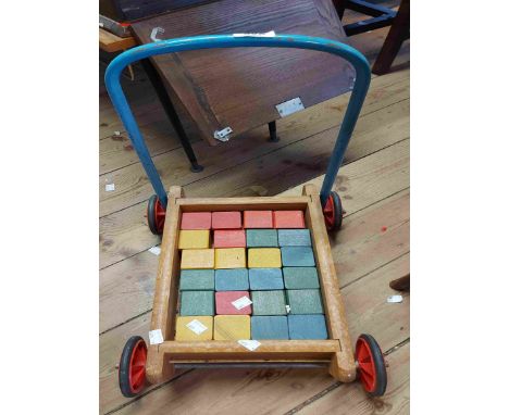 A vintage children's baby walker with building blocks