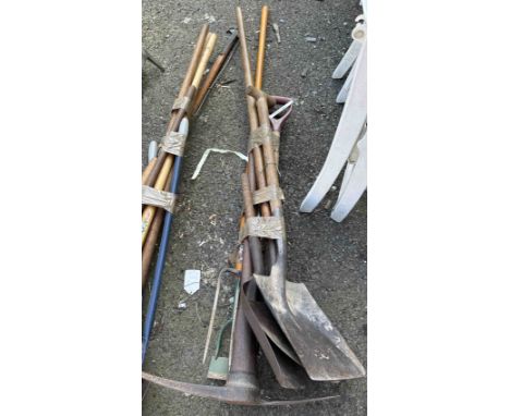 A quantity of garden tools including pickaxe, shovel, etc.