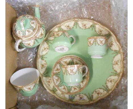 A Royal Worcester bone china cabaret set comprising teapot, two demi-tasse cups and saucers, milk jug and sugar bowl, set on 