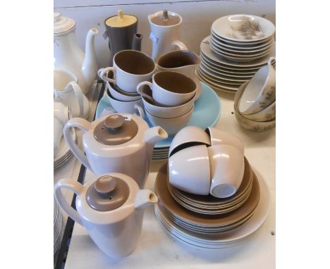 A quantity of vintage Poole Pottery tableware including coffee pots, hot water jugs, cups and saucers, plates, etc.