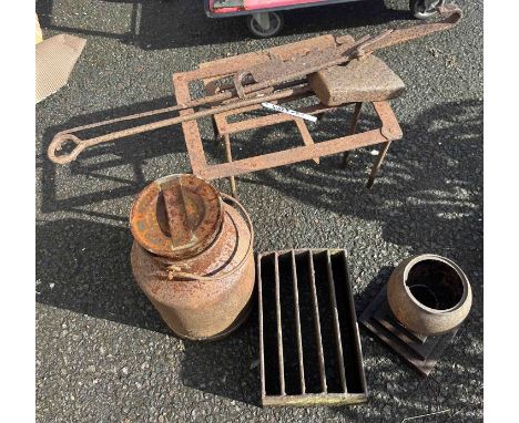 A quantity of cast iron bygones including trivets, milk churn, pot jack, urn, etc.