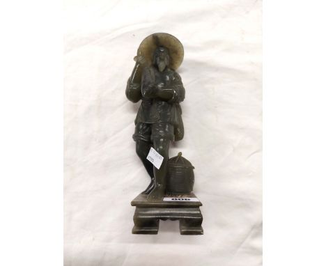 A vintage Chinese green soapstone statue, depicting a fisherman holding a fish