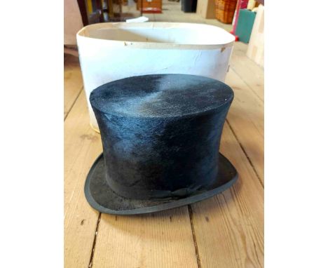 A boxed Christies silk top hat - formerly used as a costume prop in a Plymouth theatre