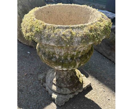 A small concrete garden urn of classical form
