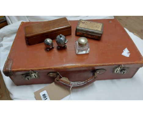 A small vintage leather suitcase containing a cased set of German gold weighing scales, a tin of spirit stains, two small EPN