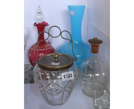 A cranberry glass claret decanter with gilt and enamel decoration, a blue glass vase, a cut glass biscuit barrel with silver 