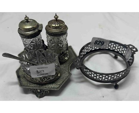 An antique cut glass and EPNS cruet set comprising glass salt, pepper and condiment dish set on a decorative embossed stand -